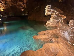 a pool of blue water in a cave at Maison du Chapitre in Prudhomat