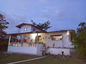 a small white house with a porch at night at Senderos de Ana in San Carlos +22 photos