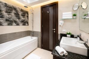 a bathroom with a tub and a sink at Blue Lotus Nile Suites Hotel Aswan in Aswan +24 photos