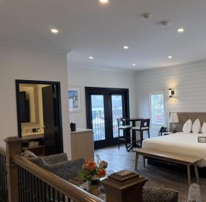 a bedroom with a bed and a living room at Colonial Hotel & Suites in Grand Bend +138 photos