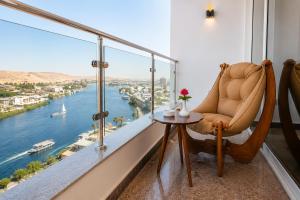 a room with a chair and a view of the water at Blue Lotus Nile Suites Hotel Aswan in Aswan