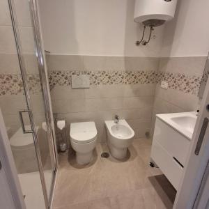 a bathroom with a toilet and a sink at Antica Dimora Ceri in Ceri
