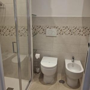 a bathroom with a shower and a toilet and a sink at Antica Dimora Ceri in Ceri