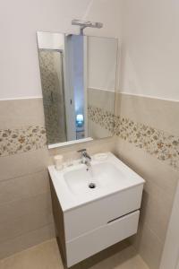 a bathroom with a white sink and a mirror at Antica Dimora Ceri in Ceri +15 photos