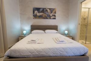 a bedroom with a large bed with towels on it at Antica Dimora Ceri in Ceri