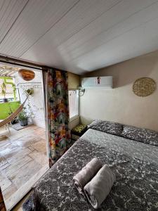 a bedroom with a bed and a couch in a room at Hostel New Ipanema in Rio de Janeiro