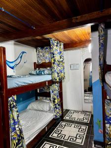 a room with three bunk beds in a train at Hostel New Ipanema in Rio de Janeiro