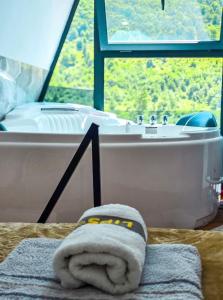 a bathroom with a bath tub and a towel at Arditi's Chalets in Bogë +41 photos