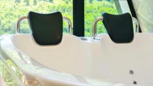 two chairs sitting in a bath tub in front of a window at Arditi's Chalets in Bogë