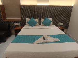 a hotel room with a bed with a hat on it at Hotel Tals Hytek in Hyderabad