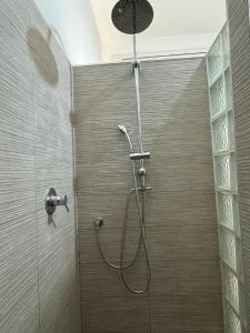 a shower with a shower head in a bathroom at Casa Vacanze Nantò 2 in Santa Maria di Castellabate