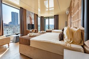 a hotel room with two beds and a large window at Hotel Eterna Hill Rooftop in Sajmište +41 photos