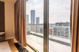 a room with a large window with a view of the city at Hotel Eterna Hill Rooftop in Sajmište