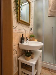 a bathroom with a white sink and a shower at Station Comfort House in Pagani +7 photos