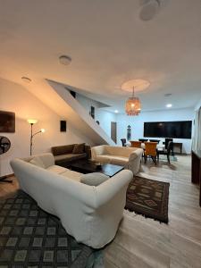 a living room with white couches and a piano at Shadamaltess in Azuretti