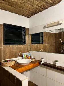 a bathroom with a white sink and a counter at Shadamaltess in Azuretti +21 photos