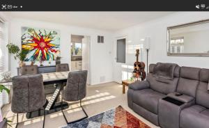 a living room with a table and a couch at Cozy Flat in Steyning