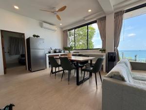 a kitchen with a table and chairs and a refrigerator at V36A Horizon in Haad Yao