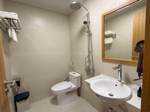a bathroom with a toilet and a sink and a mirror at Sơn Trà 668 in Sa Vi Xom +18 photos