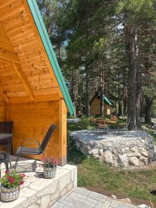 a porch of a cabin with chairs and a table at Apartman Boro in Žabljak