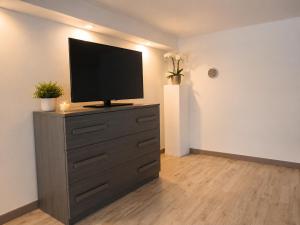 a television on top of a dresser in a room at Urban charme loft in Dorgali +18 photos