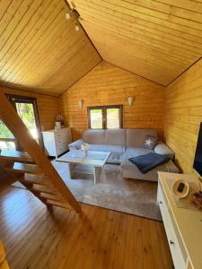 a living room with a couch and a table at Bungalow am Hafen in Dierhagen
