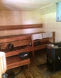 a small kitchen with a bench and a stove at Glamping teltta Venekoski in Hankasalmi