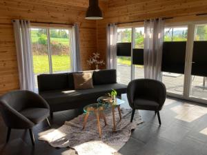 a living room with a couch and two chairs and a table at Hagens Cottage in Wanfried