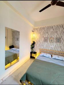a bedroom with two beds and a wall at HideAway in Hyderabad