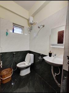 a bathroom with a toilet and a sink at HideAway in Hyderabad +4 photos