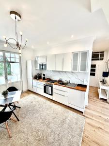 a kitchen with white cabinets and a table at Parkresidenz Viktoria Luise in Bad Salzuflen