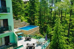 an aerial view of a house with a swimming pool at Aachman Nature Valley Resort MASHOBRA in Shimla