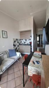 a living room with a couch and a table at Terrazza Enjoy in Letojanni