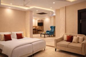 a hotel room with a bed and a chair at Aachman Nature Valley Resort MASHOBRA in Shimla