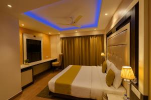 a hotel room with a bed and a blue ceiling at Aachman Nature Valley Resort MASHOBRA in Shimla +32 photos