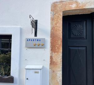 a sign on a building next to a door at Apartment Lagma in Železniki