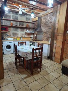 a kitchen with a table and chairs and a stove at Casa Sabinar in Navajas