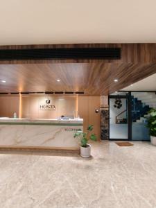 a lobby of a hotel with a reception counter at Hosta Inn Hotel and Resort in Edappāl