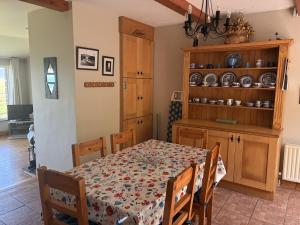 a dining room with a table and a kitchen at St Ann's Rossbeigh in Glenbeigh