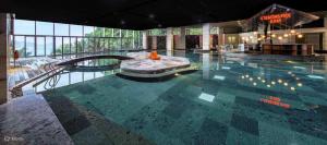 a large swimming pool in a large building at Flamingo Cát Bà Sea Residence , Sky Villa Premier Ocean View King Bed in Hai Phong