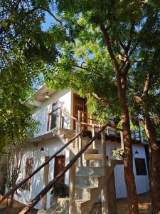 a house with stairs leading up to it at Casa Momo Playa Zipolite Oaxaca in Zipolite