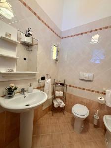 a bathroom with a sink and a toilet at La Casa Sulla Scogliera in Cefalù +43 photos
