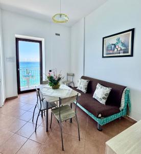 a living room with a couch and a table at La Casa Sulla Scogliera in Cefalù