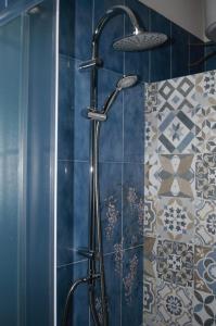 a shower with a shower head in a bathroom at B&B Sulla Spiaggia in Belmonte Calabro +20 photos