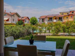 a dining table with chairs and a view of houses at New Home Lazise in Lazise