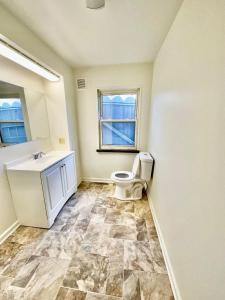 a bathroom with a toilet and a sink at Newly Renovated Quiant 2-bed 2-bath Apt in Wilmington