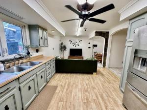 a kitchen with a ceiling fan and a living room at Newly Renovated Quiant 2-bed 2-bath Apt in Wilmington +6 photos