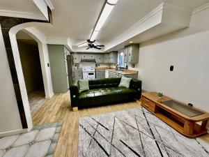 a living room with a black couch and a kitchen at Newly Renovated Quiant 2-bed 2-bath Apt in Wilmington