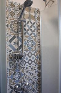a bathroom with a shower with tiles on the wall at B&B Fronte mare in Belmonte Calabro +36 photos