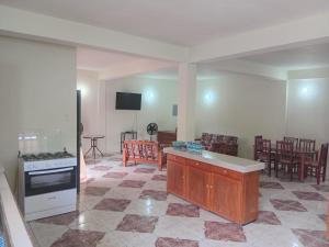 a kitchen with a stove and a living room at Parakeet Hideaway in Mason Hall